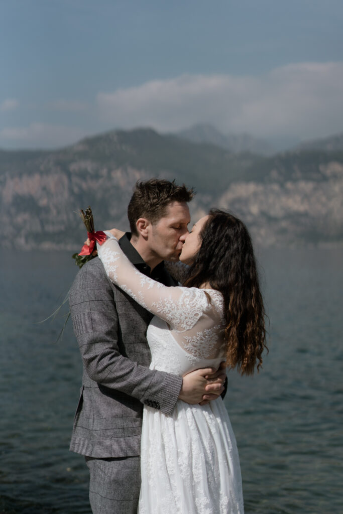 Couple kissing by Lake Garda during their Malcesine elopement in Italy