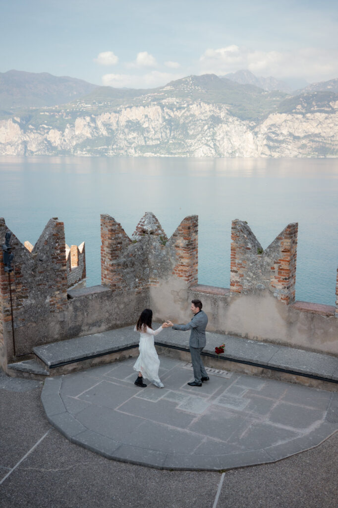 Couple dancing on the terrace of Malcesine Castle during their Lake Garda elopement