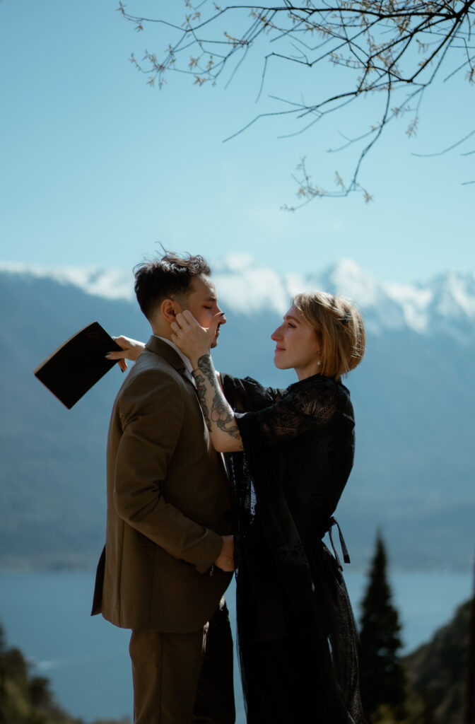 Couple sharing an emotional vow moment during their Limone del Garda elopement with Lake Garda behind them
