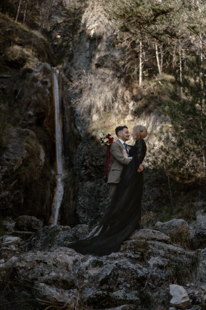 Couple embracing near a waterfall during their Limone del Garda elopement
