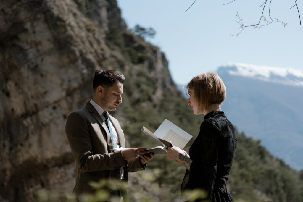 Couple reading personal vows during their Limone del Garda elopement on Lake Garda
