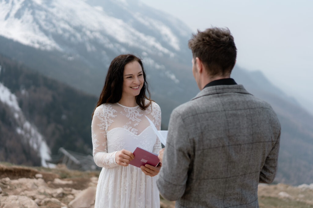 Bride reading vows on Monte Baldo during a Malcesine elopement above Lake Garda