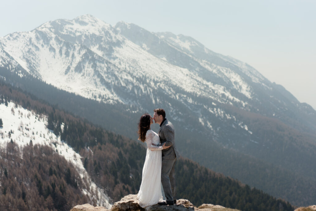 Couple kissing on Monte Baldo during their Malcesine elopement above Lake Garda