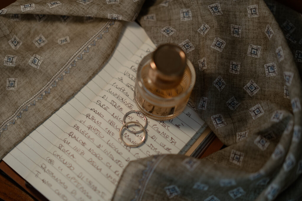 Wedding rings and handwritten vows during a Lake Tenno LGBTQ+ elopement in Italy