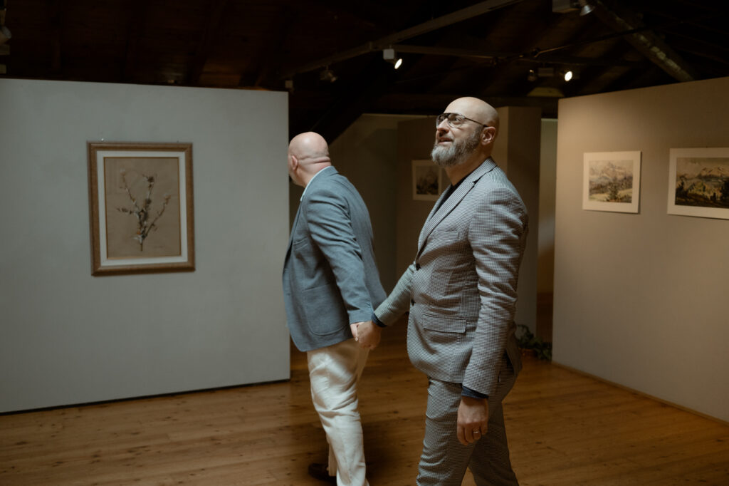 LGBTQ+ couple walking hand in hand during their elopement in Riva del Garda