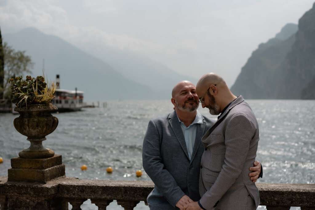 Couple holding each other by Lake Garda during their Riva del Garda elopement