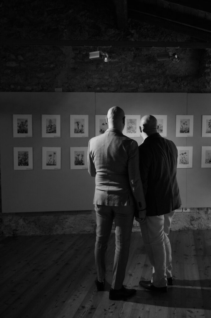 Black and white photo of a couple holding hands during their Lake Garda elopement