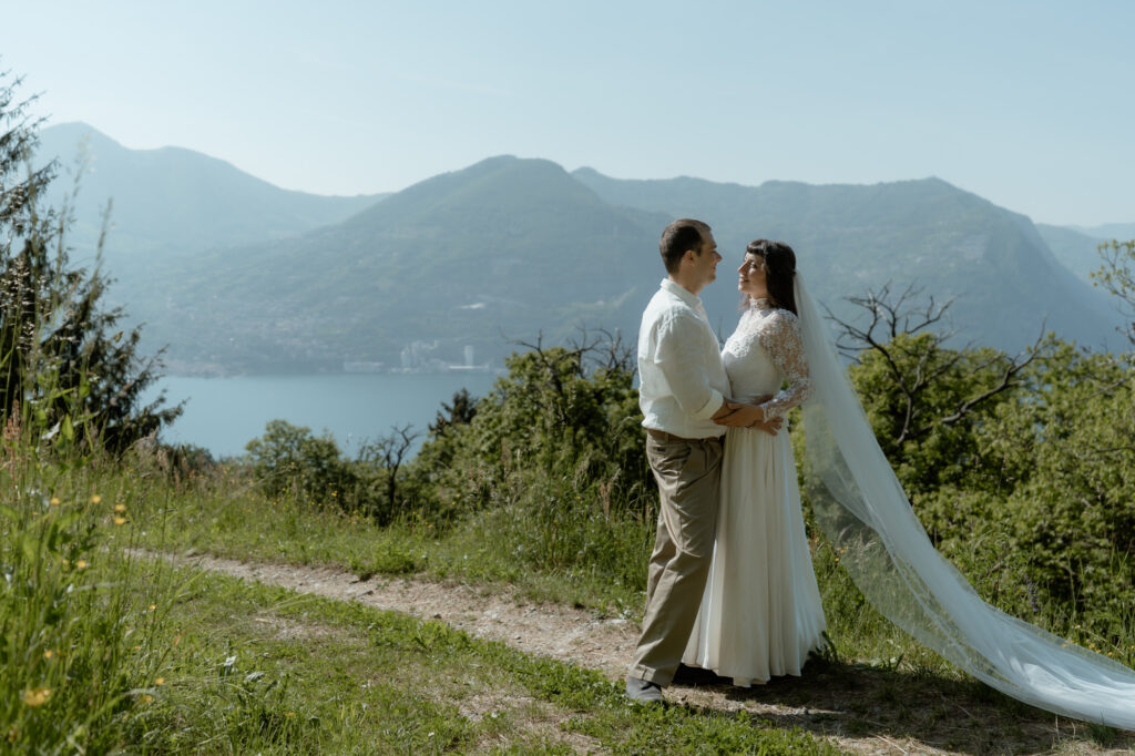 Couple standing together with a long veil during their Monte Isola elopement on Lake Iseo