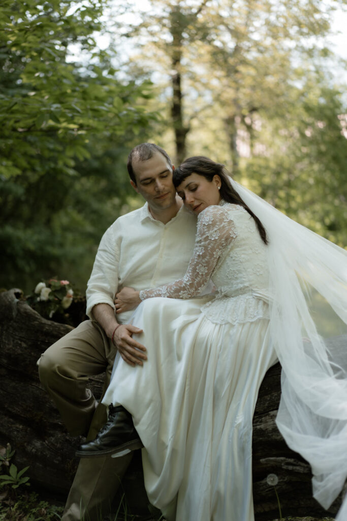 Couple sitting together in the woods during their Monte Isola Lake Iseo elopement