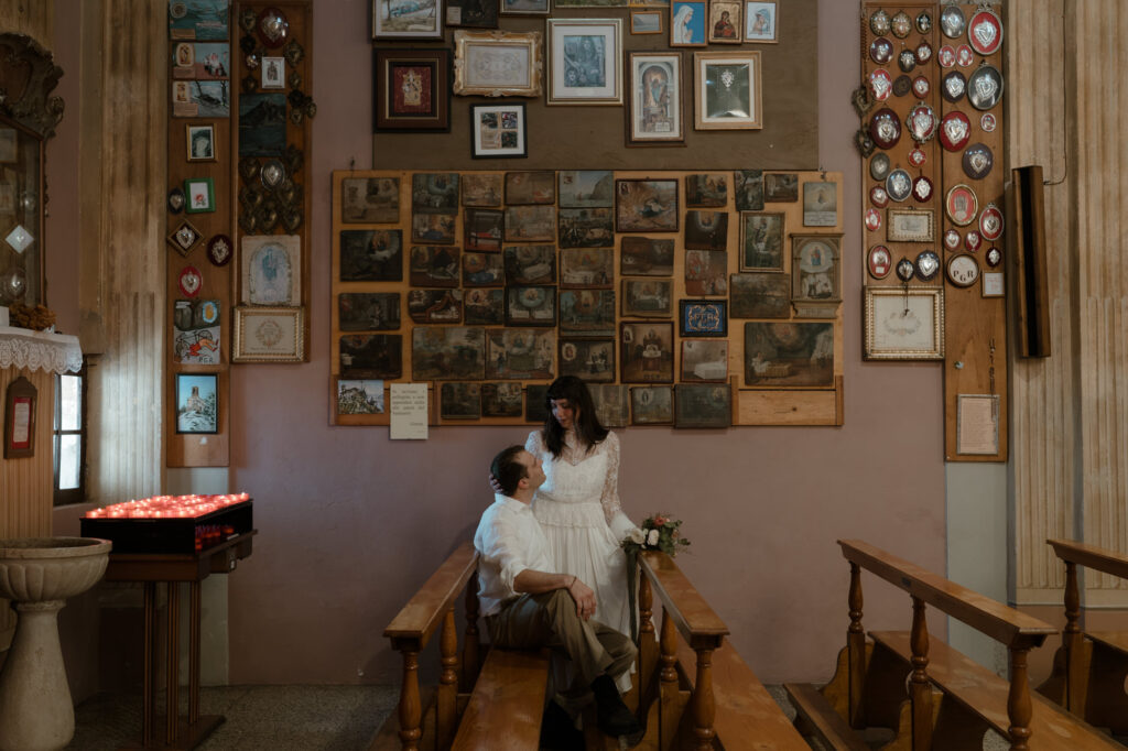Couple sitting inside a church during their Monte Isola elopement on Lake Iseo