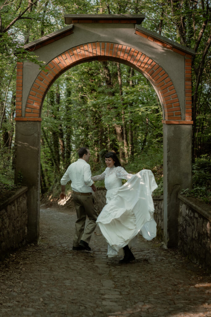 Couple walking under a woodland arch during their Monte Isola elopement on Lake Iseo