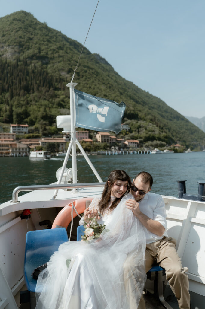 Couple laughing together on a boat during their Monte Isola elopement on Lake Iseo