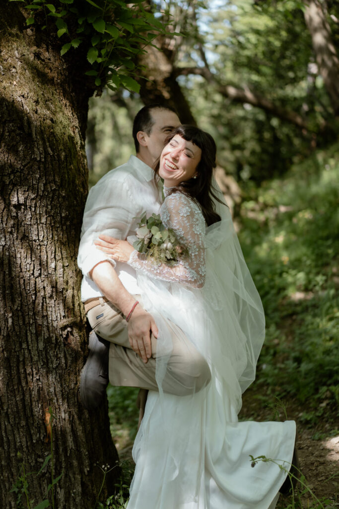 Couple embracing by a tree during their Monte Isola elopement on Lake Iseo