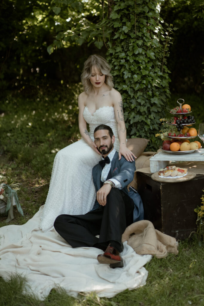 Bride and groom sitting together beside an aperitivo setup during their intimate wedding in Italy
