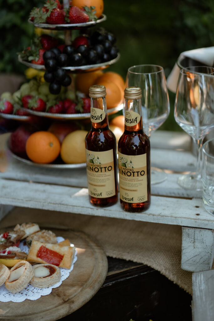 Aperitivo table with fruit, drinks, and pastries at an intimate wedding in Italy