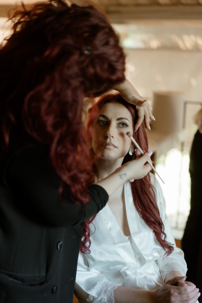 Bride getting her makeup done before an intimate wedding at a countryside villa in Italy