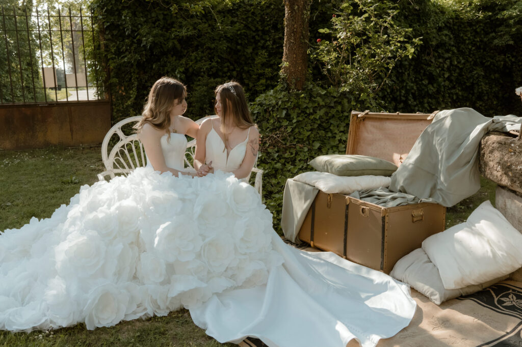 LGBTQ+ couple sitting together in a garden during an intimate wedding in Italy