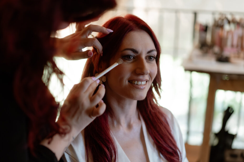 Bride having her makeup done before an intimate wedding at a countryside villa in Italy