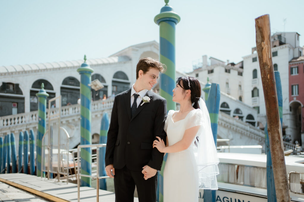 Couple standing near the Rialto Bridge area during their Venice elopement in Italy