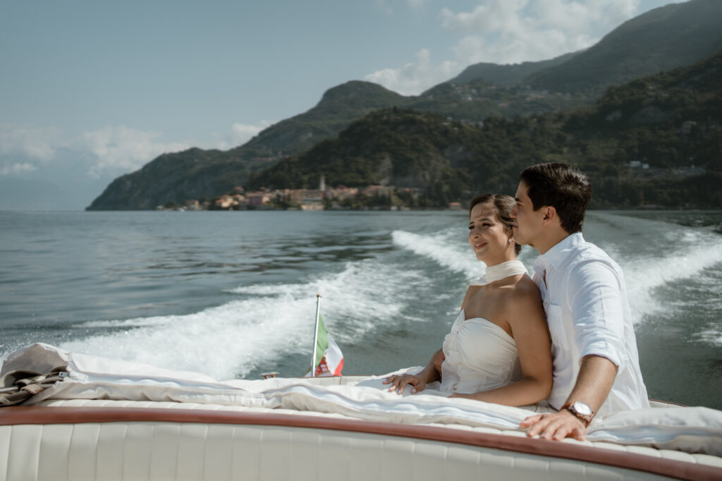 Couple sitting on a classic boat near Varenna during a Lake Como elopement session in Italy
