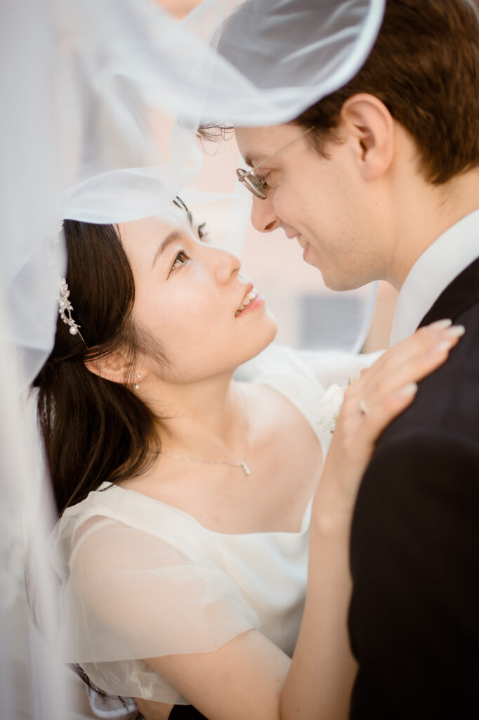 Close portrait of a couple under the bride’s veil during their Venice elopement