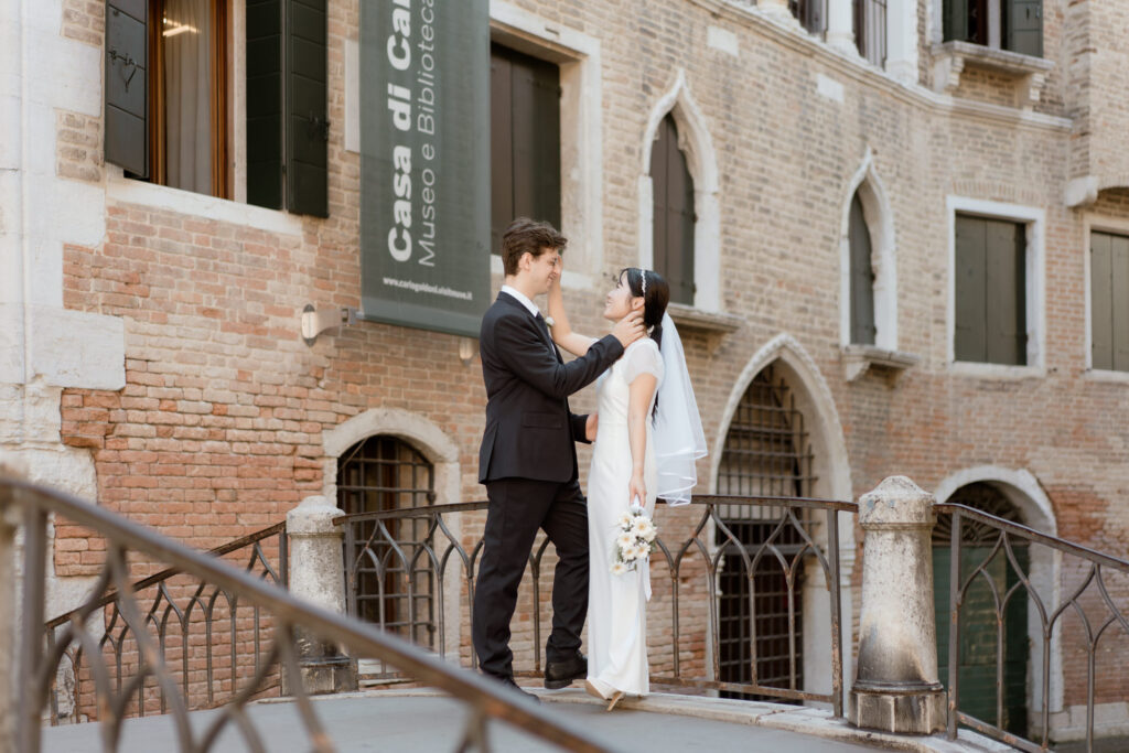 Couple standing on a bridge during their Venice elopement in Italy