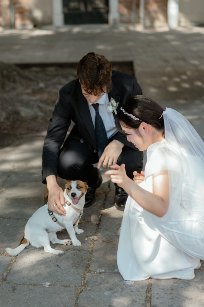 Couple petting a dog during their Venice elopement portraits in Italy