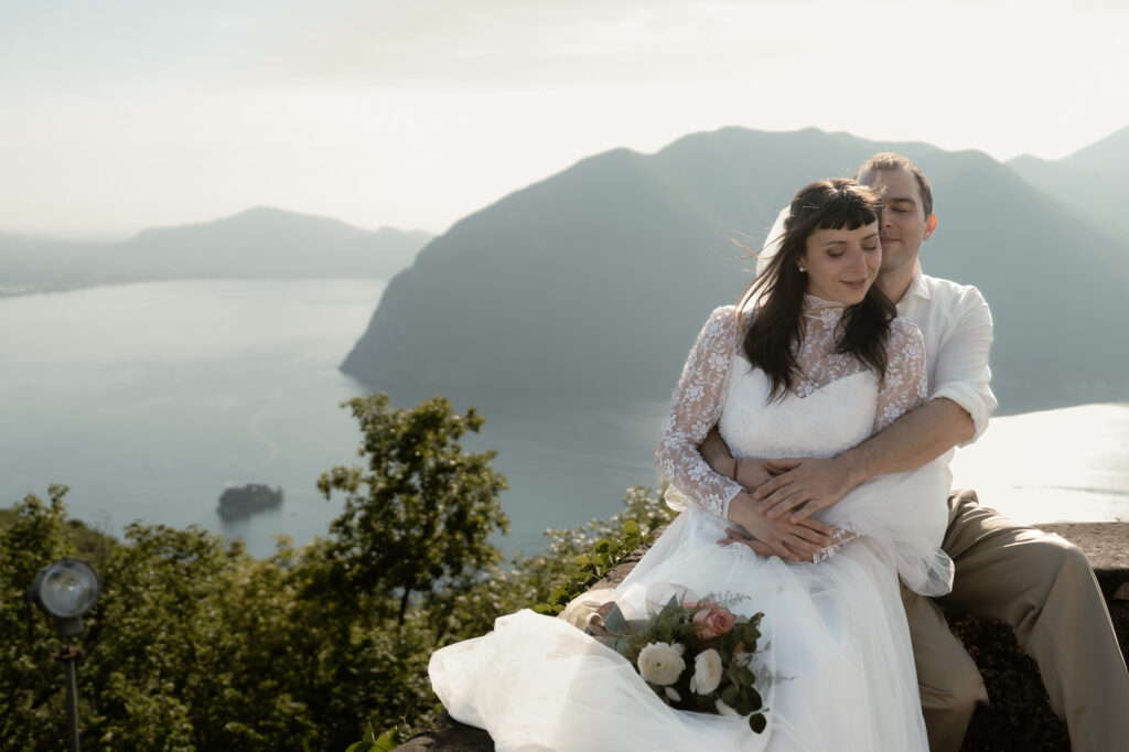Couple sitting together above Lake Iseo during their Monte Isola elopement in Italy